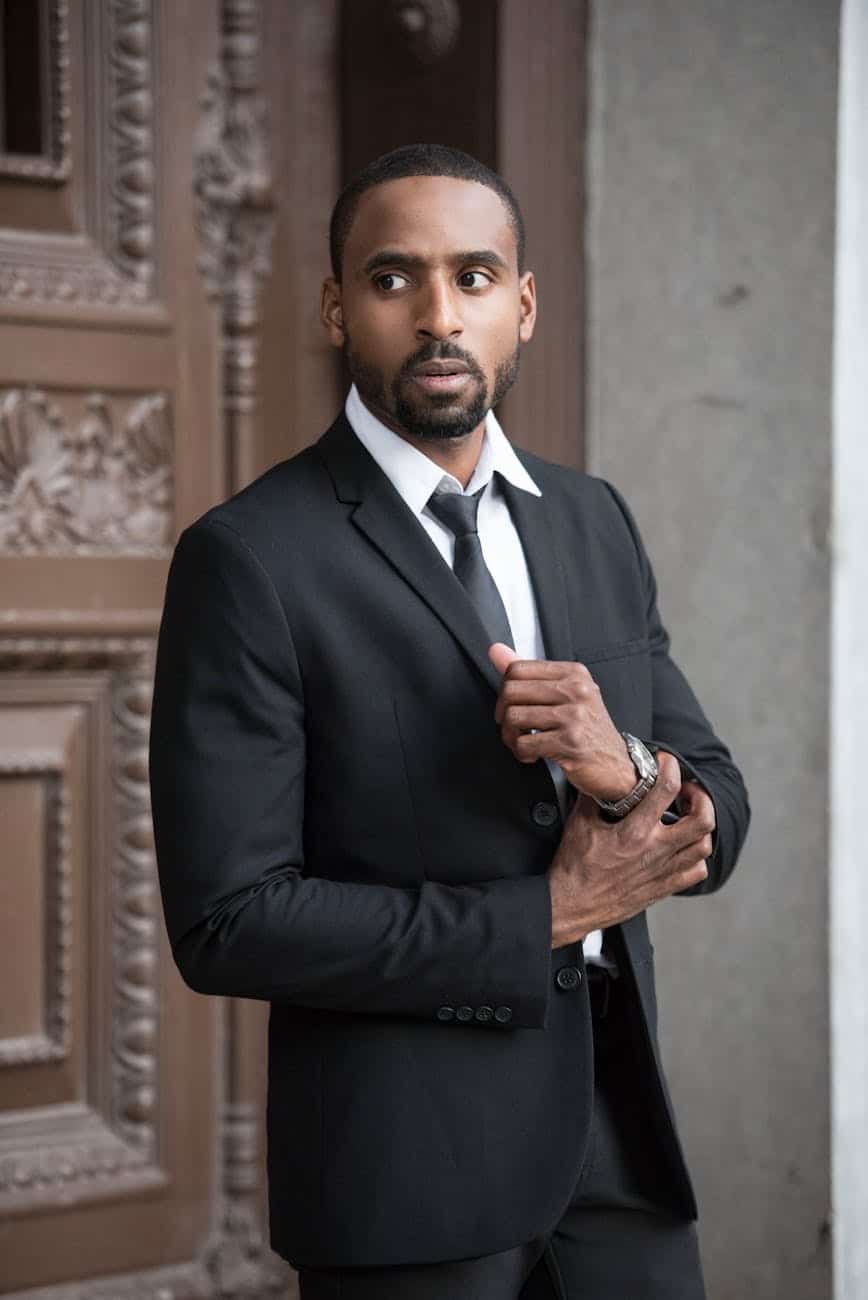 man wearing black notched lapel blazer